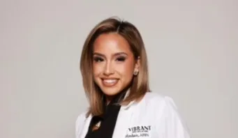 A woman wearing a white med coat