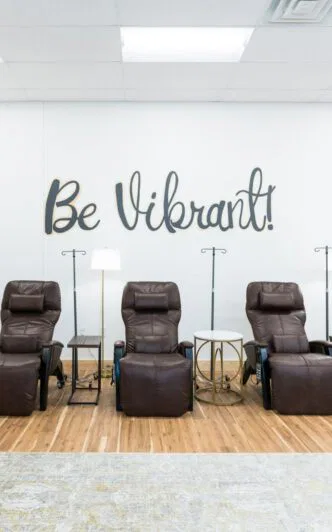 A room with five comfortable electric reclining lounge chairs in a med spa room